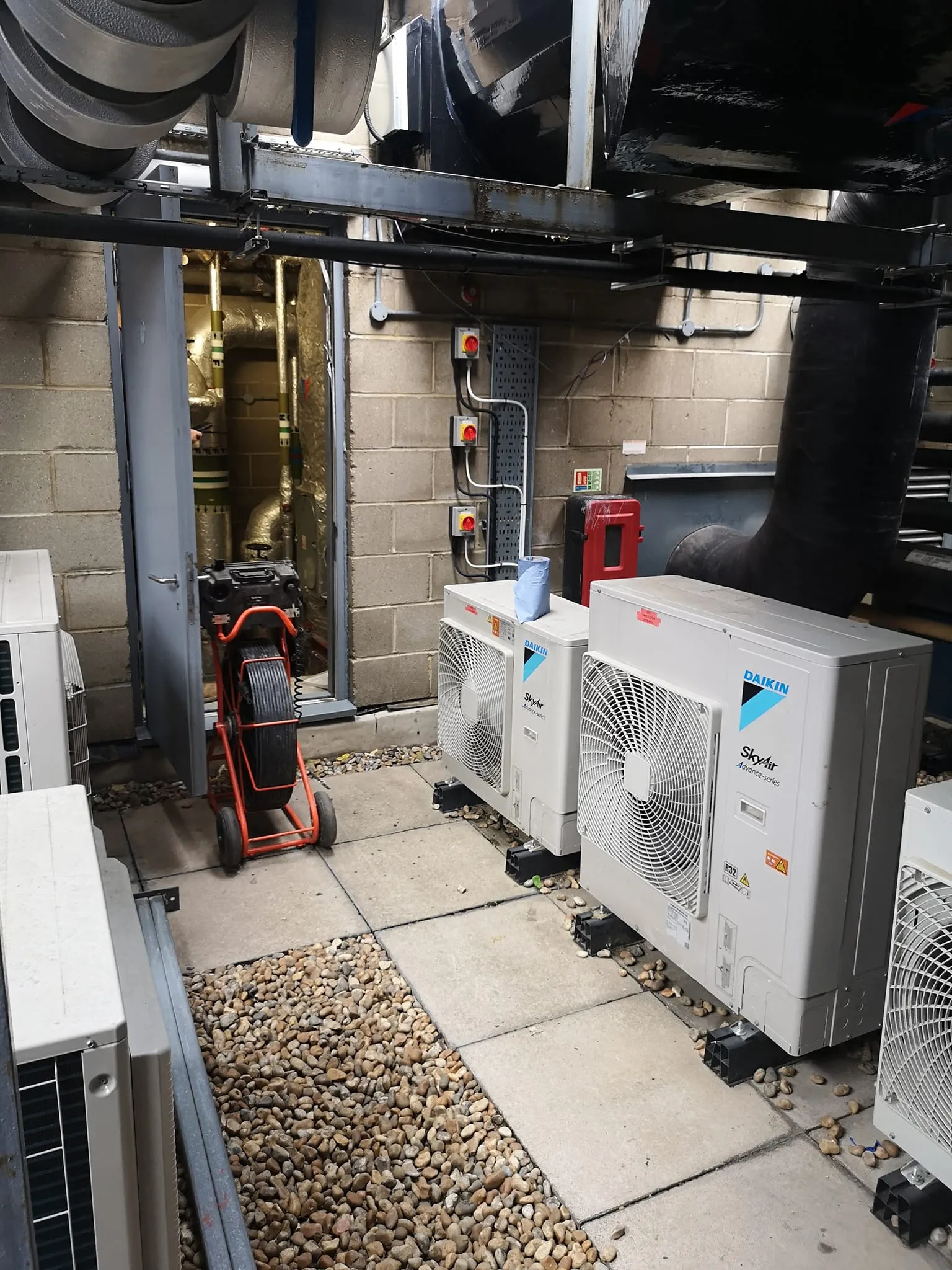 A couple of air conditioners sitting next to each other.